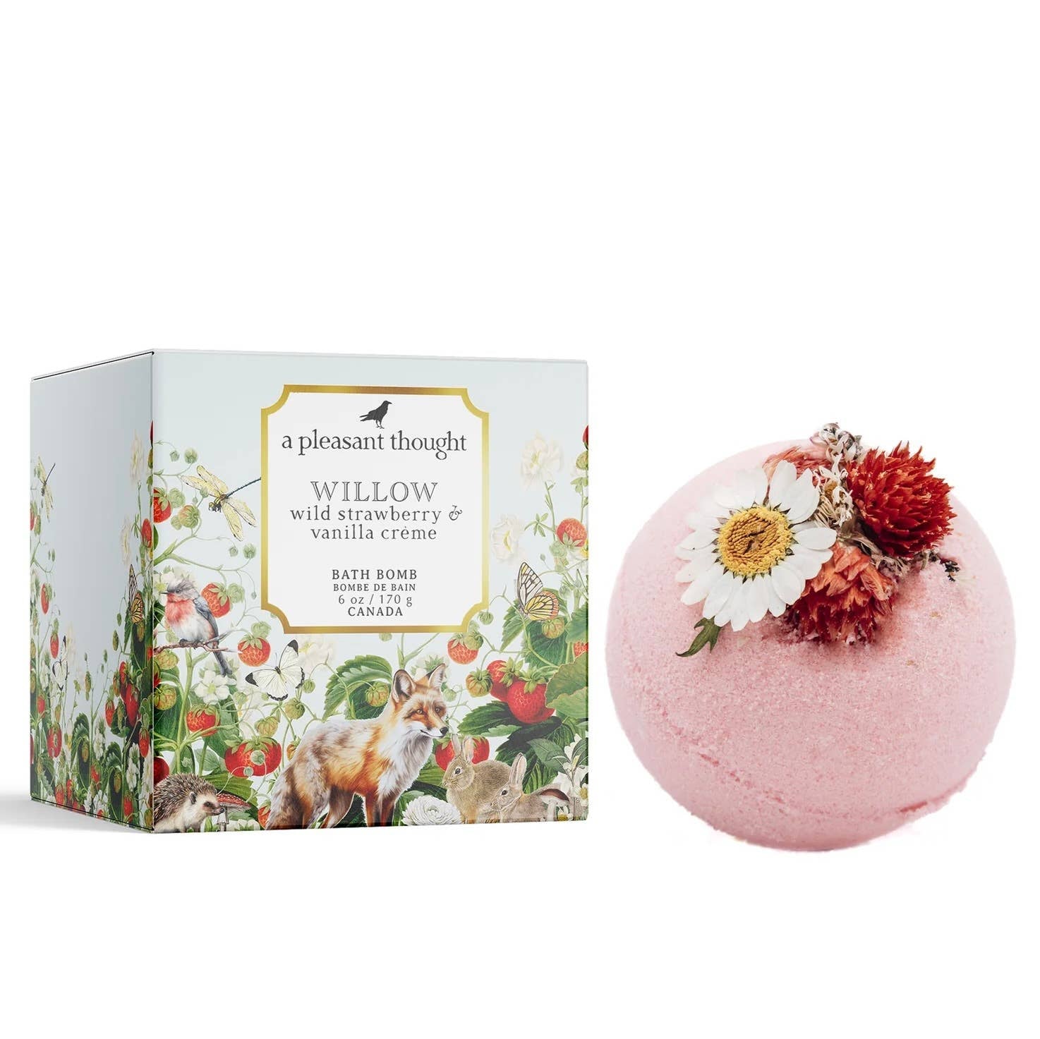 A pink bath bomb with 'A Pleasant Thought - WILLOW | WILD STRAWBERRY & VANILLA CRÈME' written on the packaging, alongside a floral decoration made with dried flowers and a sprig of greenery.