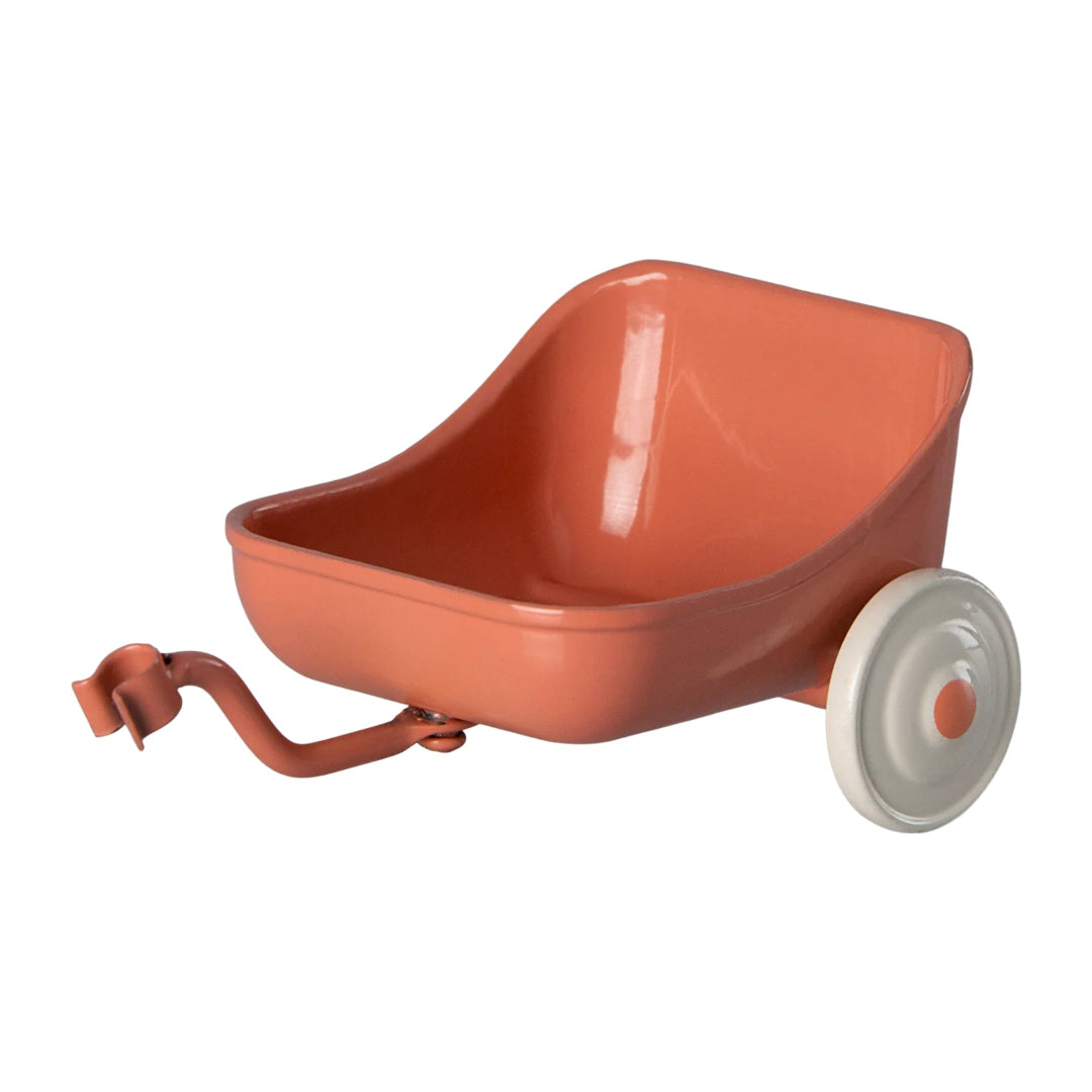 Coral tricycle wagon with a white wheel on a white background