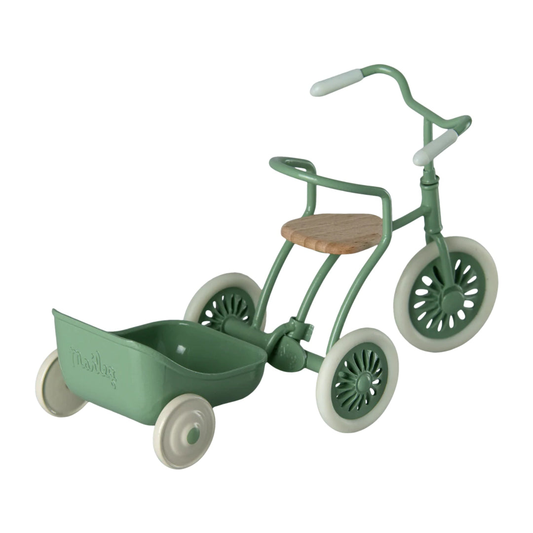Green children's tricycle with a wooden seat on a white background