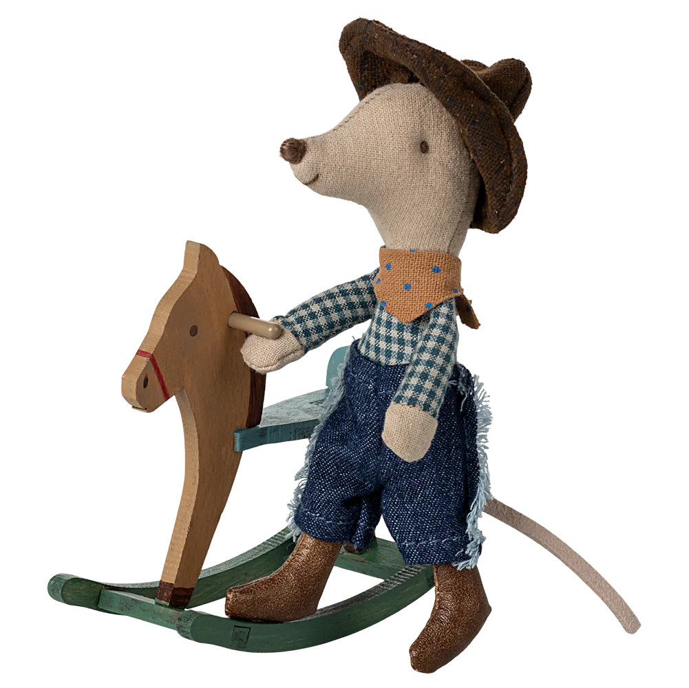 Toy mouse in cowboy outfit riding a wooden horse on a white background