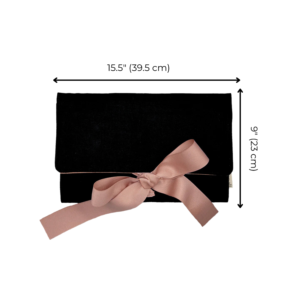 Black clutch bag with a pink bow and measurements on a white background