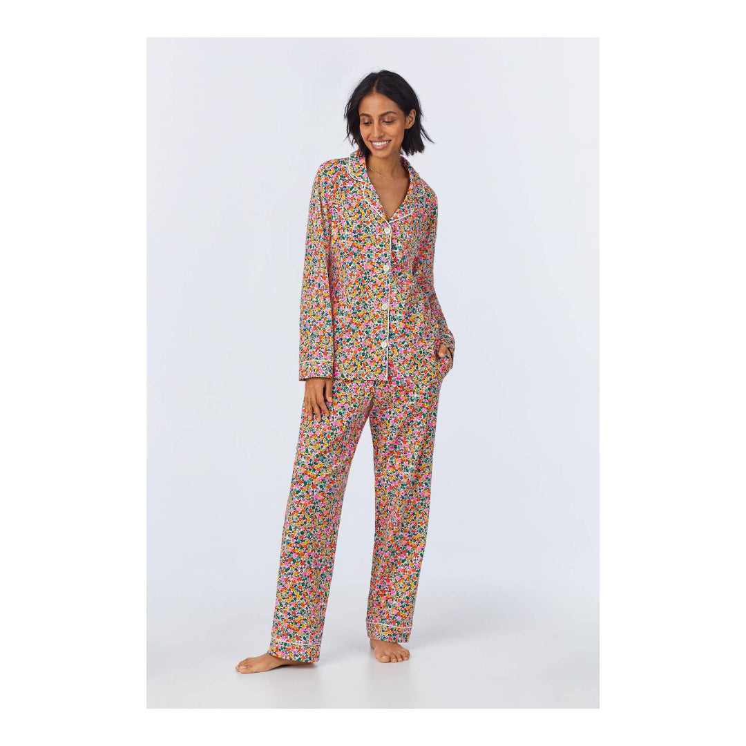 Woman wearing a colorful pajama set on a white background