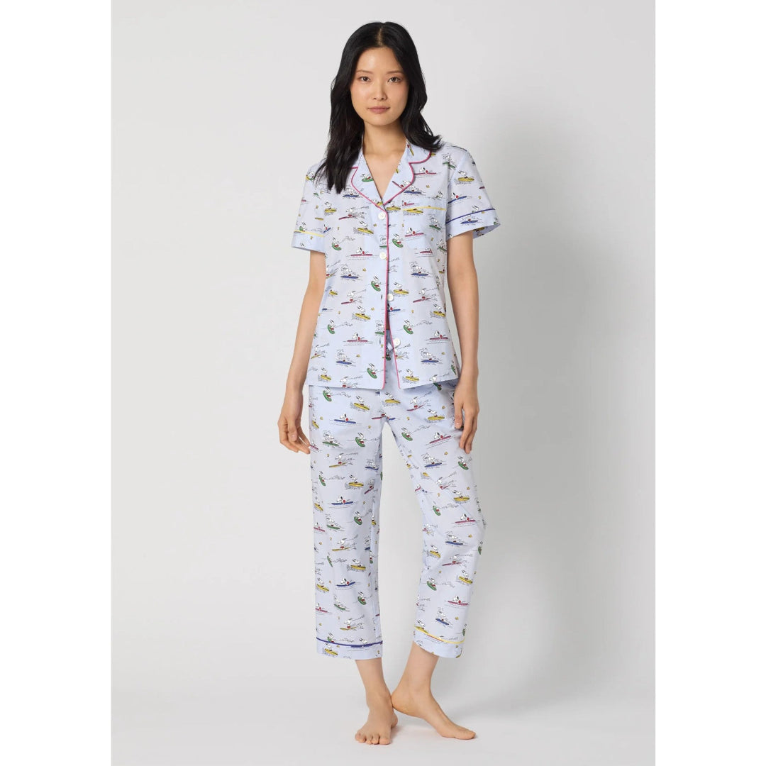 Woman wearing a patterned pajama set on a white background