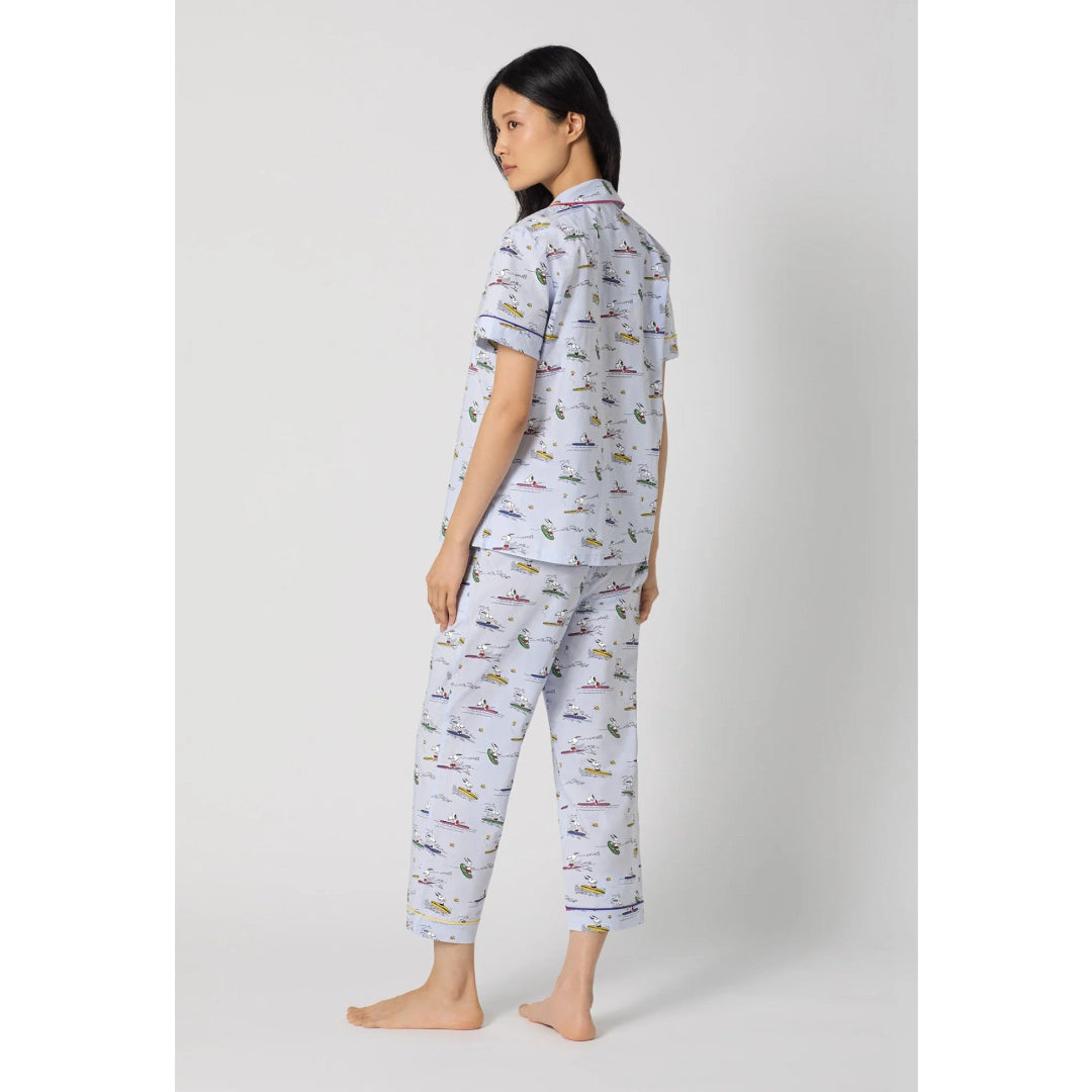 Woman wearing a patterned pajama set on a white background