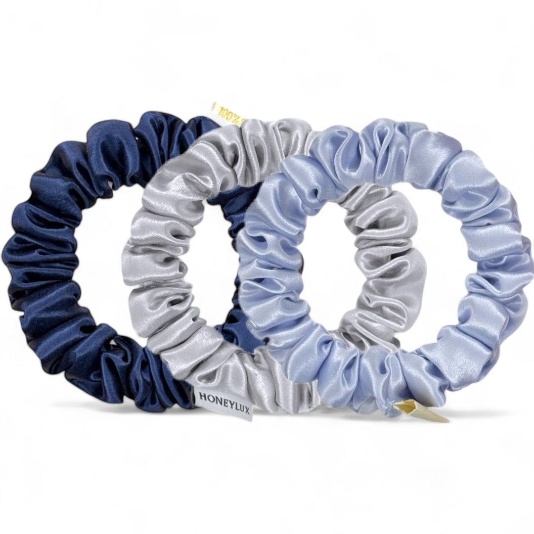 Set of three scrunchies in blue, gray, and light blue on a white background