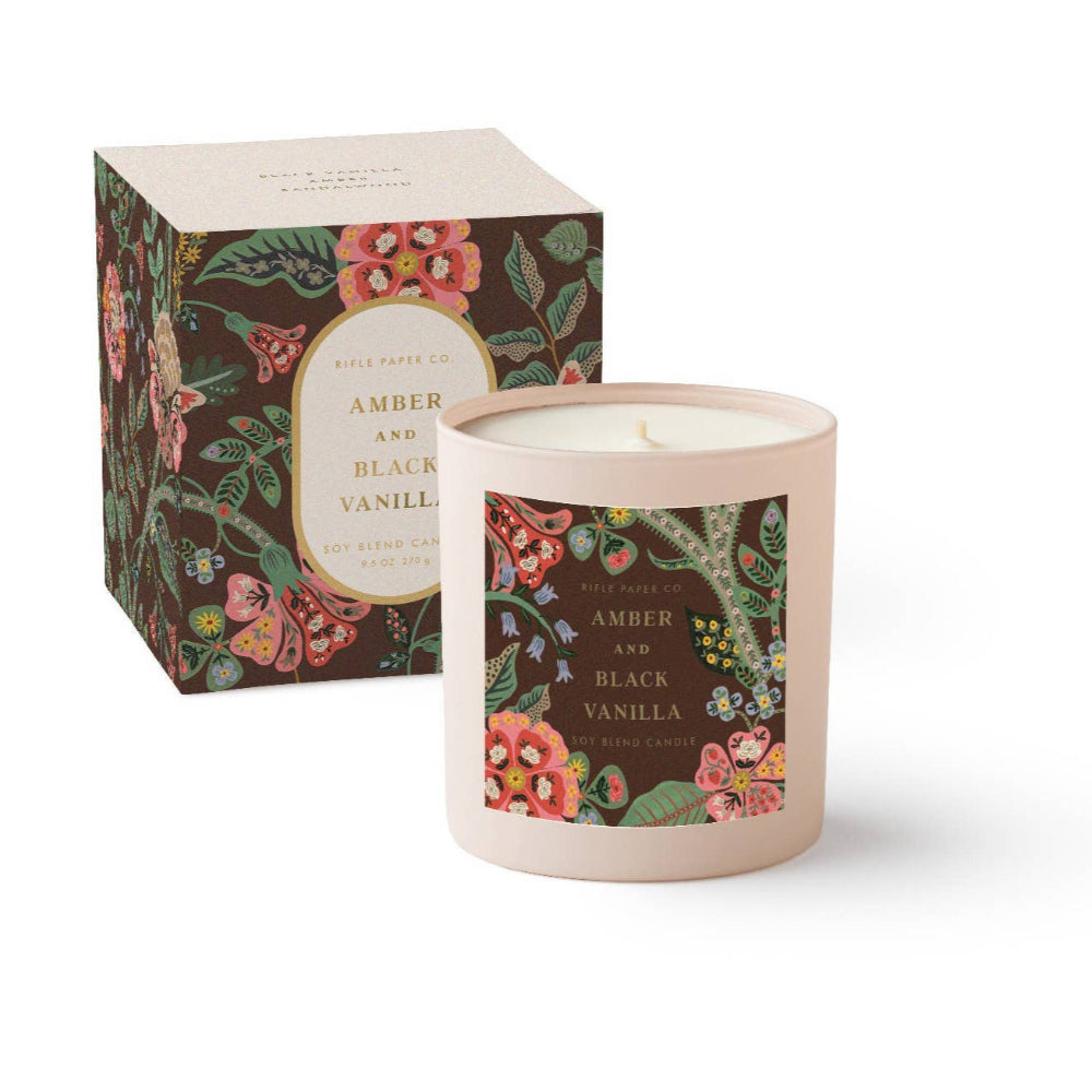 Candle with floral packaging and label on a white background