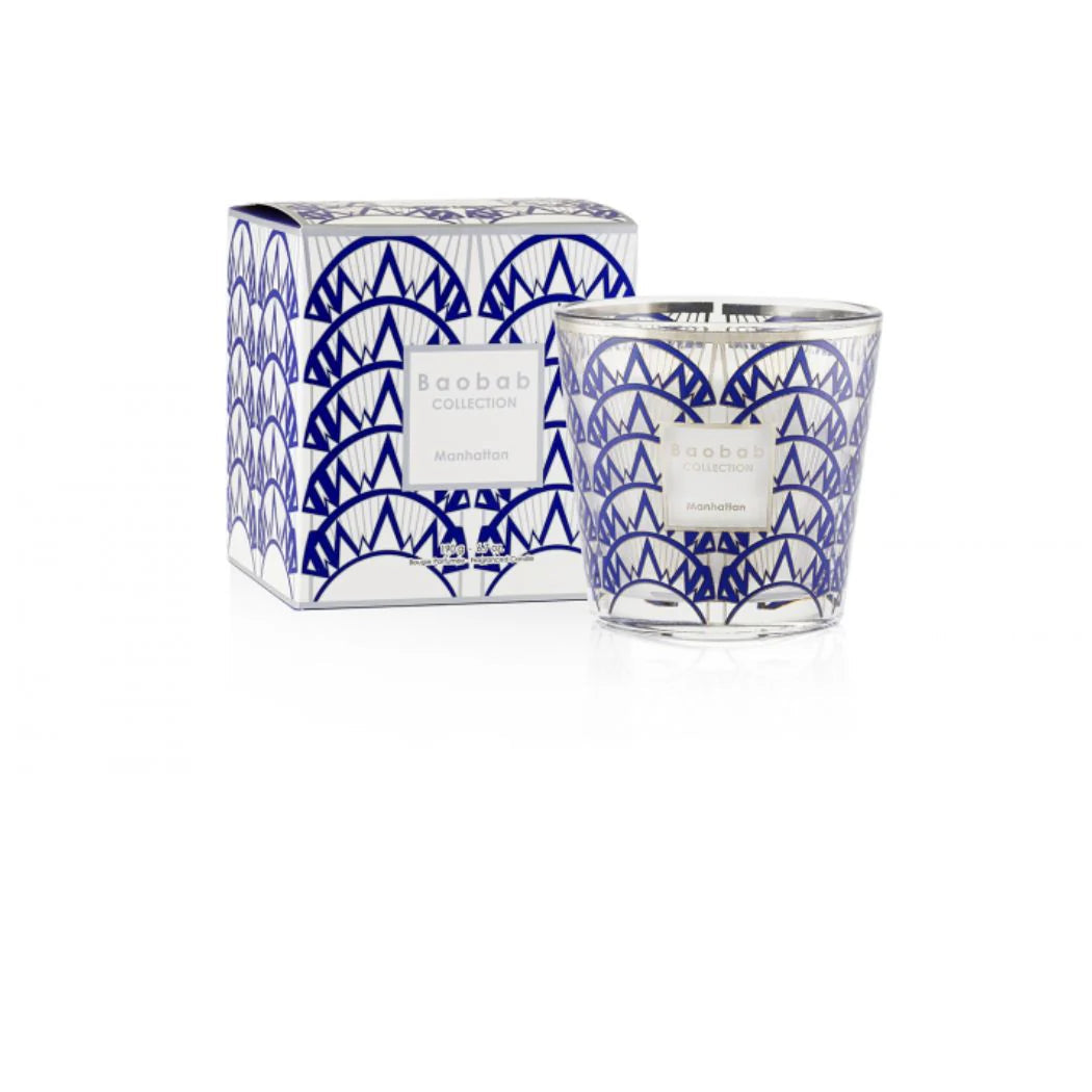 Candle with blue geometric design and matching packaging on a white background
