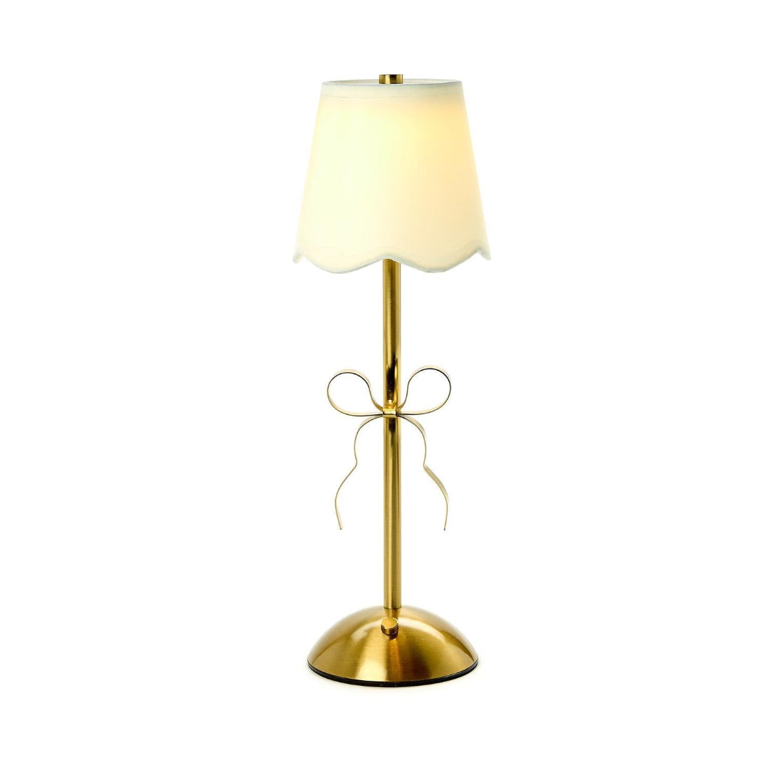 Gold table lamp with a white lampshade on a white background