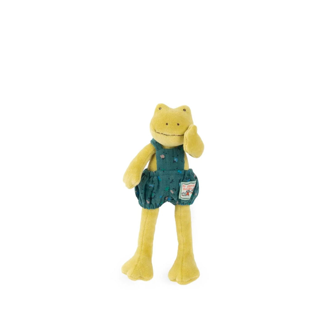 Plush toy frog wearing denim overalls on a white background