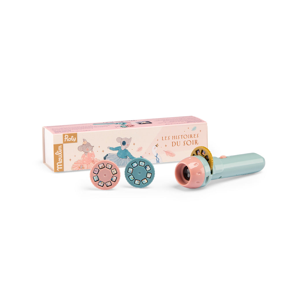 Toy with wheels and a microphone in front of its packaging on a white background
