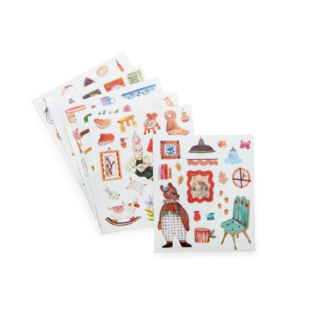 Three sheets of decorative stickers with various designs on a white background