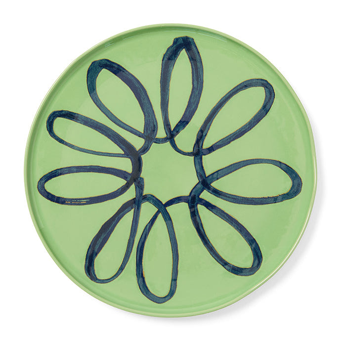 Green plate with a blue design on a white background
