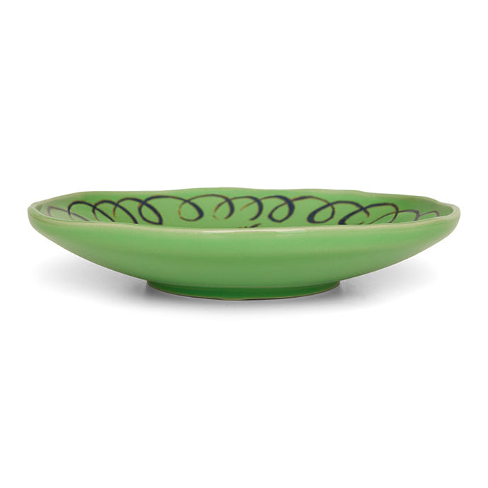Green ceramic bowl with decorative pattern on a white background