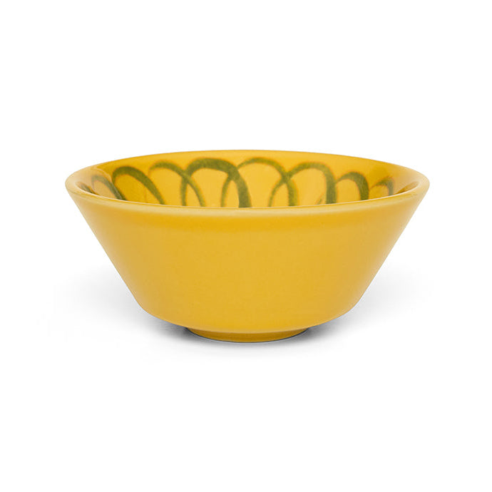 Yellow ceramic bowl with green patterns on a white background