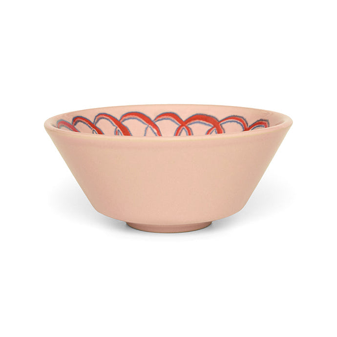 Pink ceramic bowl with a pattern on a white background