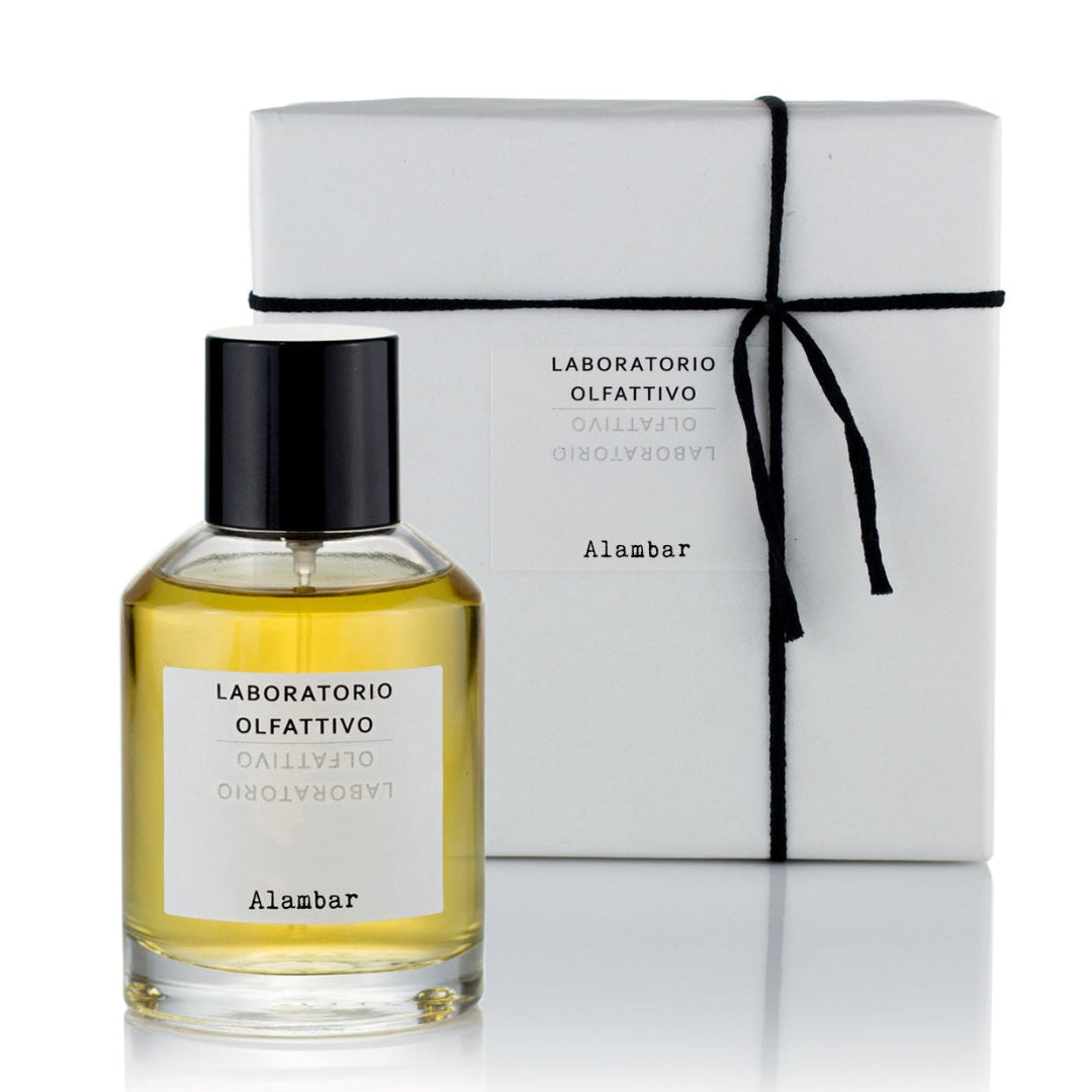 A bottle of Alambar 100ml Eau de Parfum next to its white packaging box.