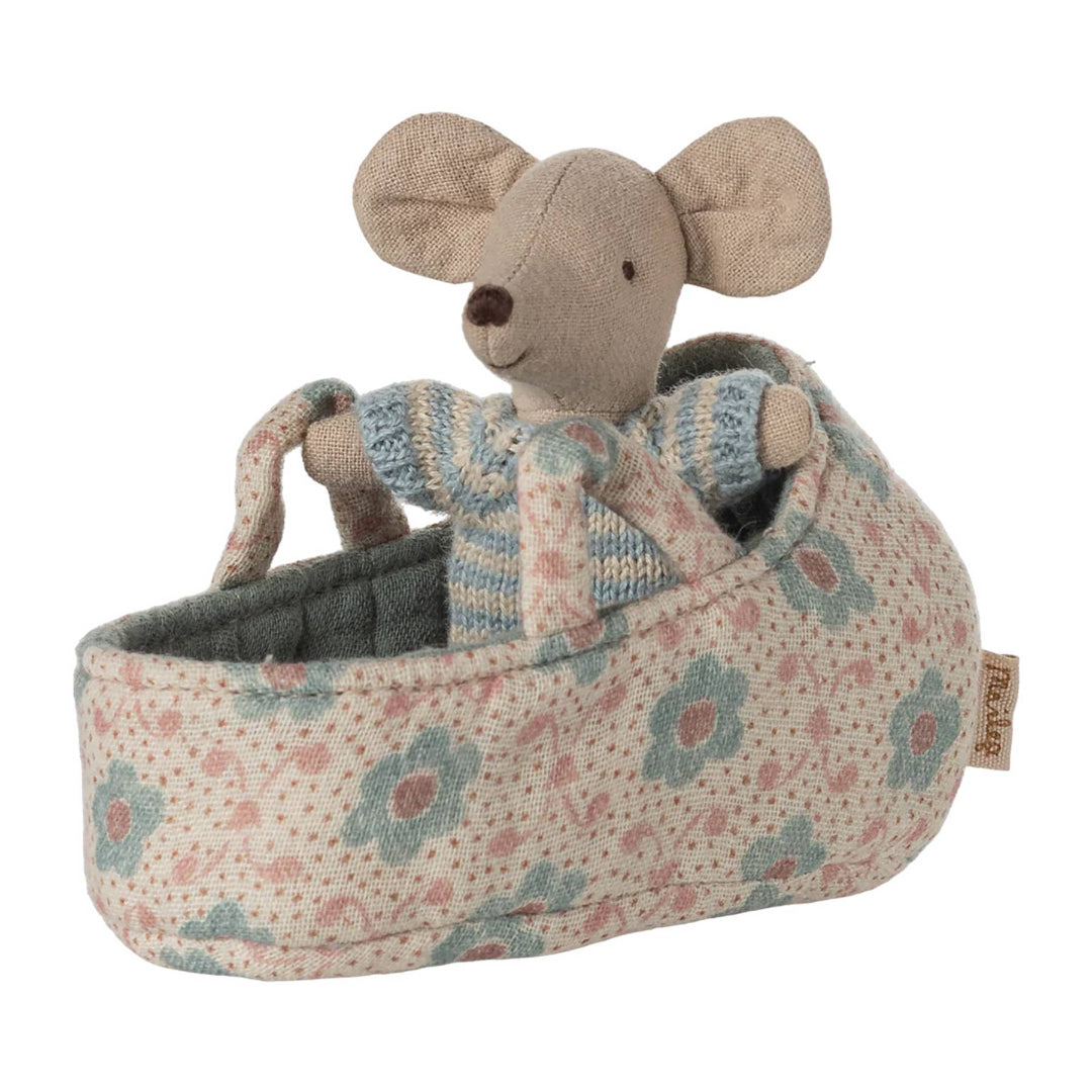 Stuffed mouse toy in a floral-patterned carrier on a white background