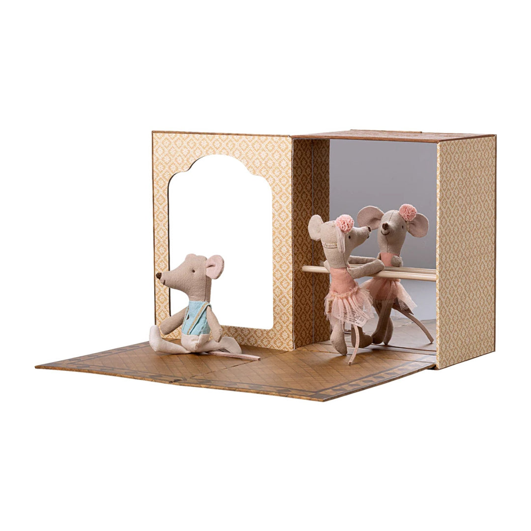 Two small mouse figurines in a decorative box on a white background