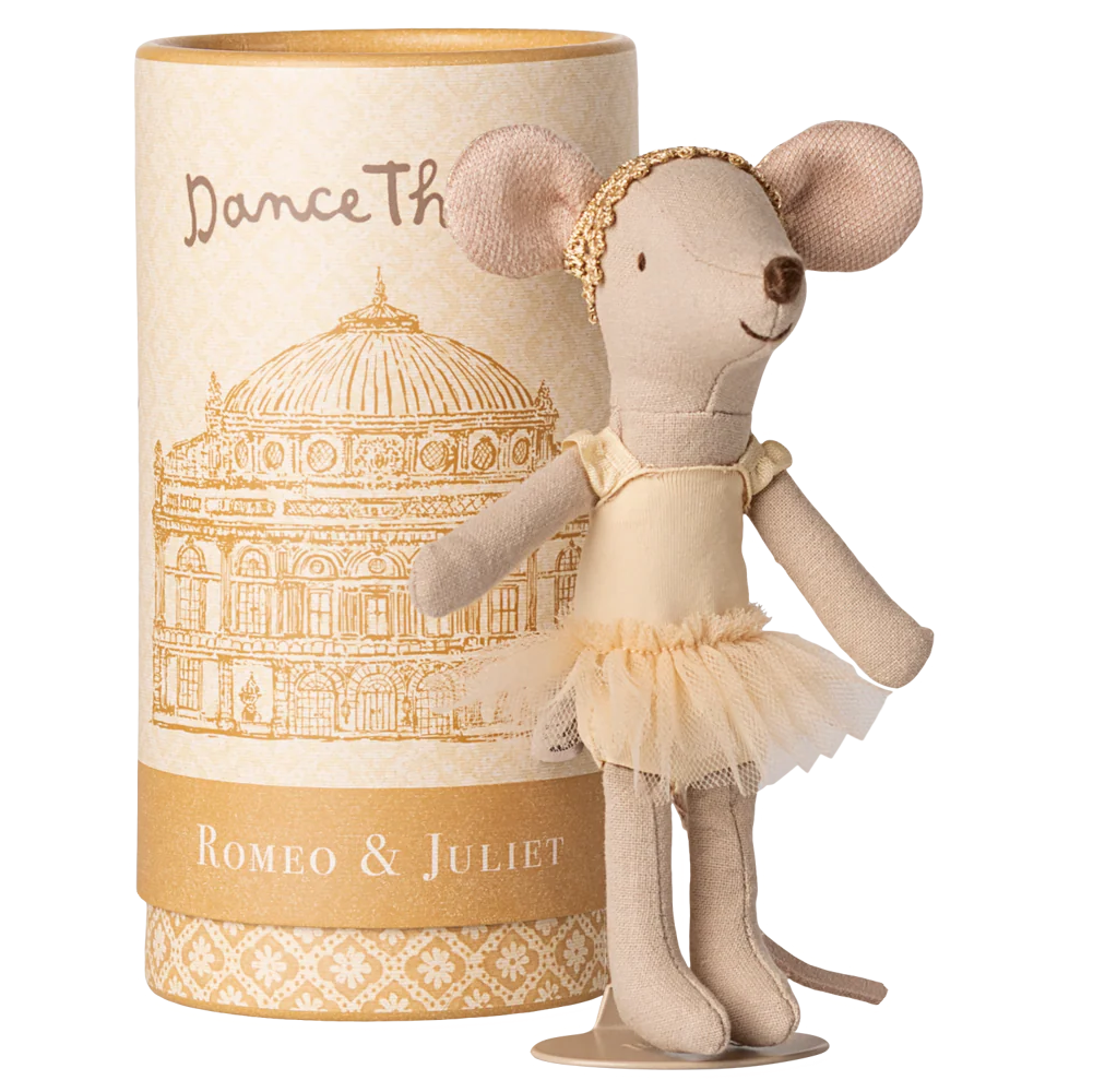 Stuffed mouse doll in a tutu dress next to a cylindrical box with decorative design and text.