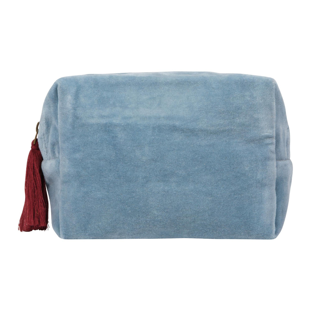 Blue velvet pouch with a red tassel on a white background