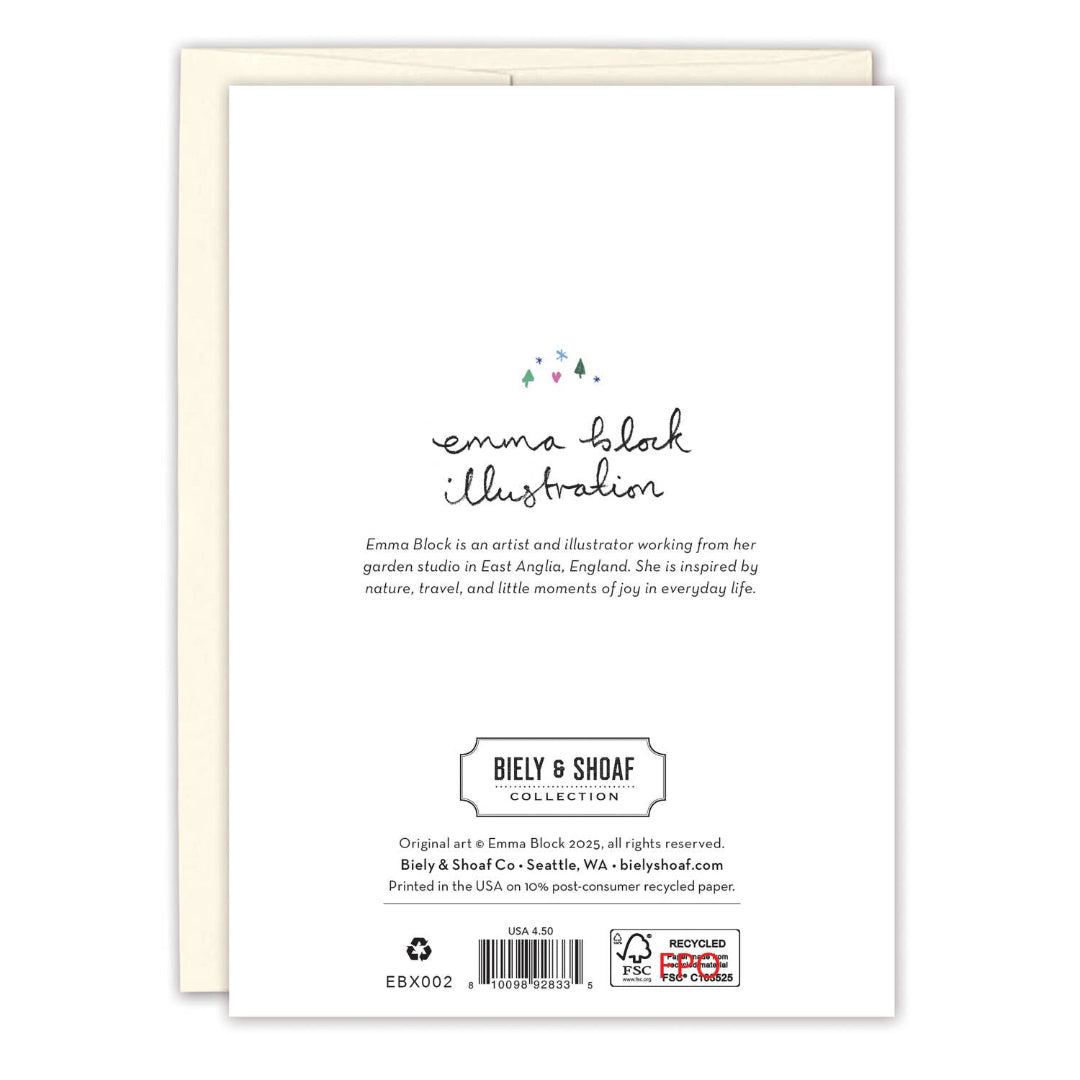 A white greeting card with black printed text and a small pastel floral accent, shown in front of a cream envelope on a white background. The card reads 'emma Block illustration' and 'BIELY & SHOAF COLLECTION'.
