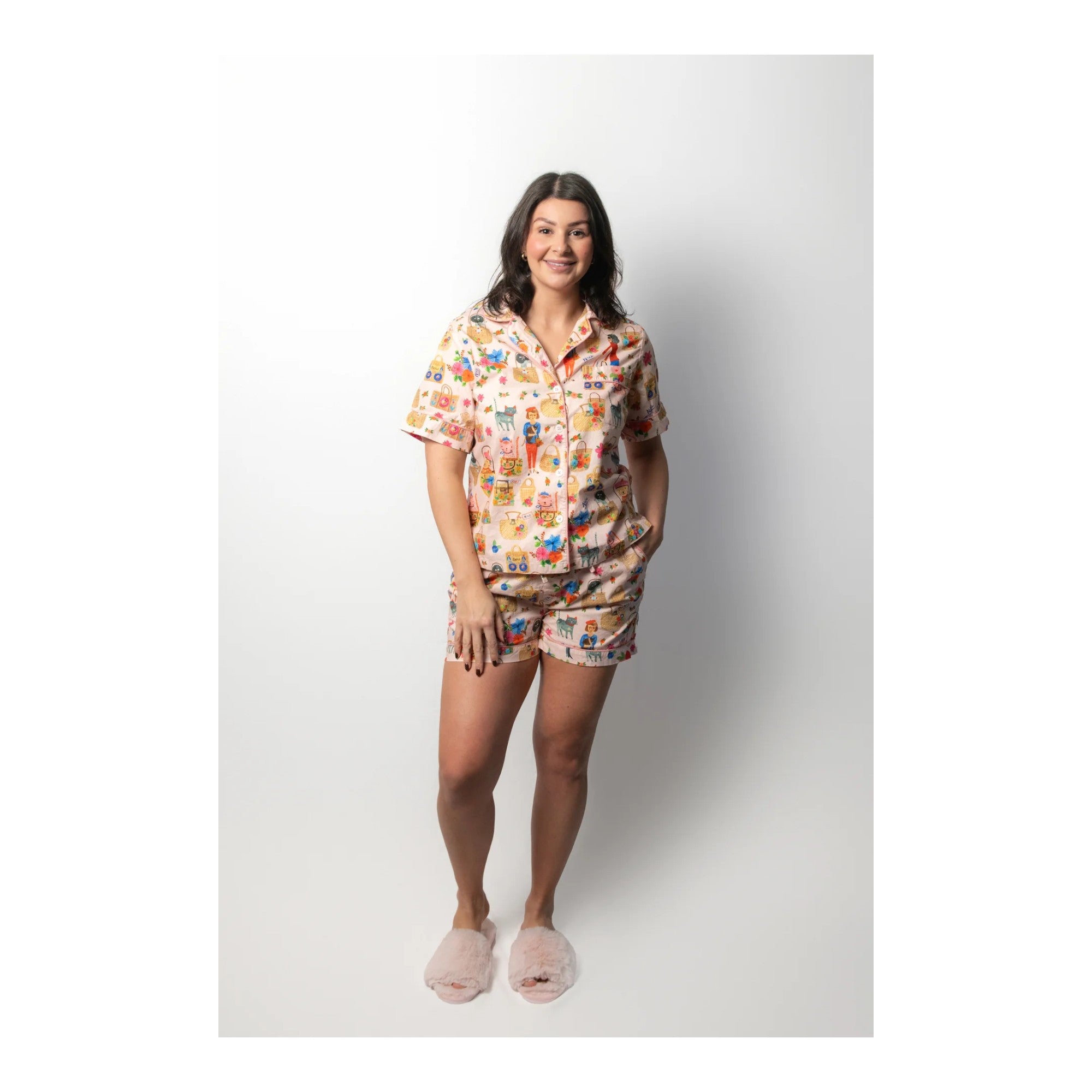 Woman wearing a patterned pajama set on a white background