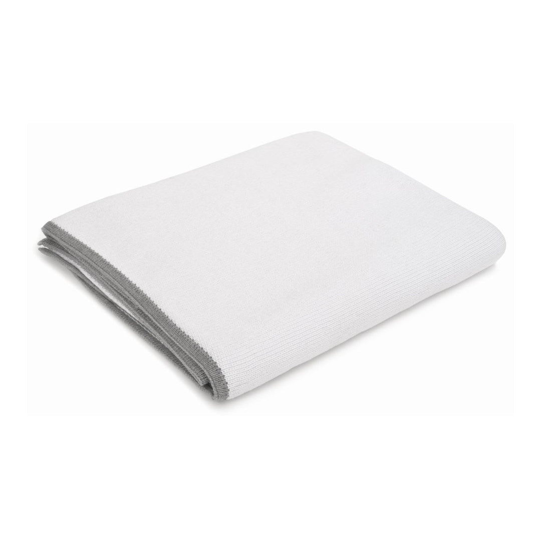 Folded white throw on a white background