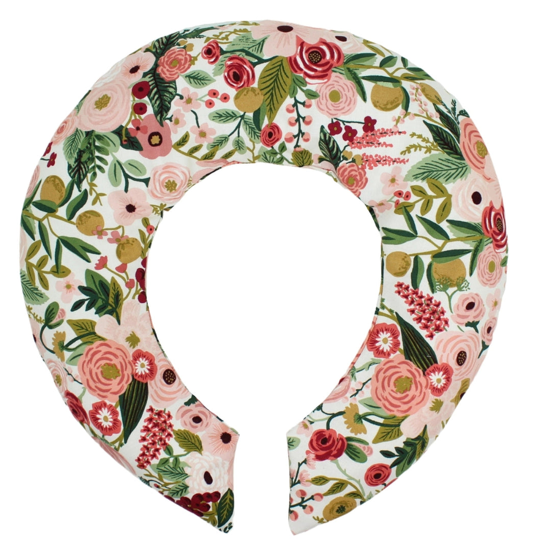 A floral printed neck wrap in mauve and green colors, featuring a removable cotton cover.