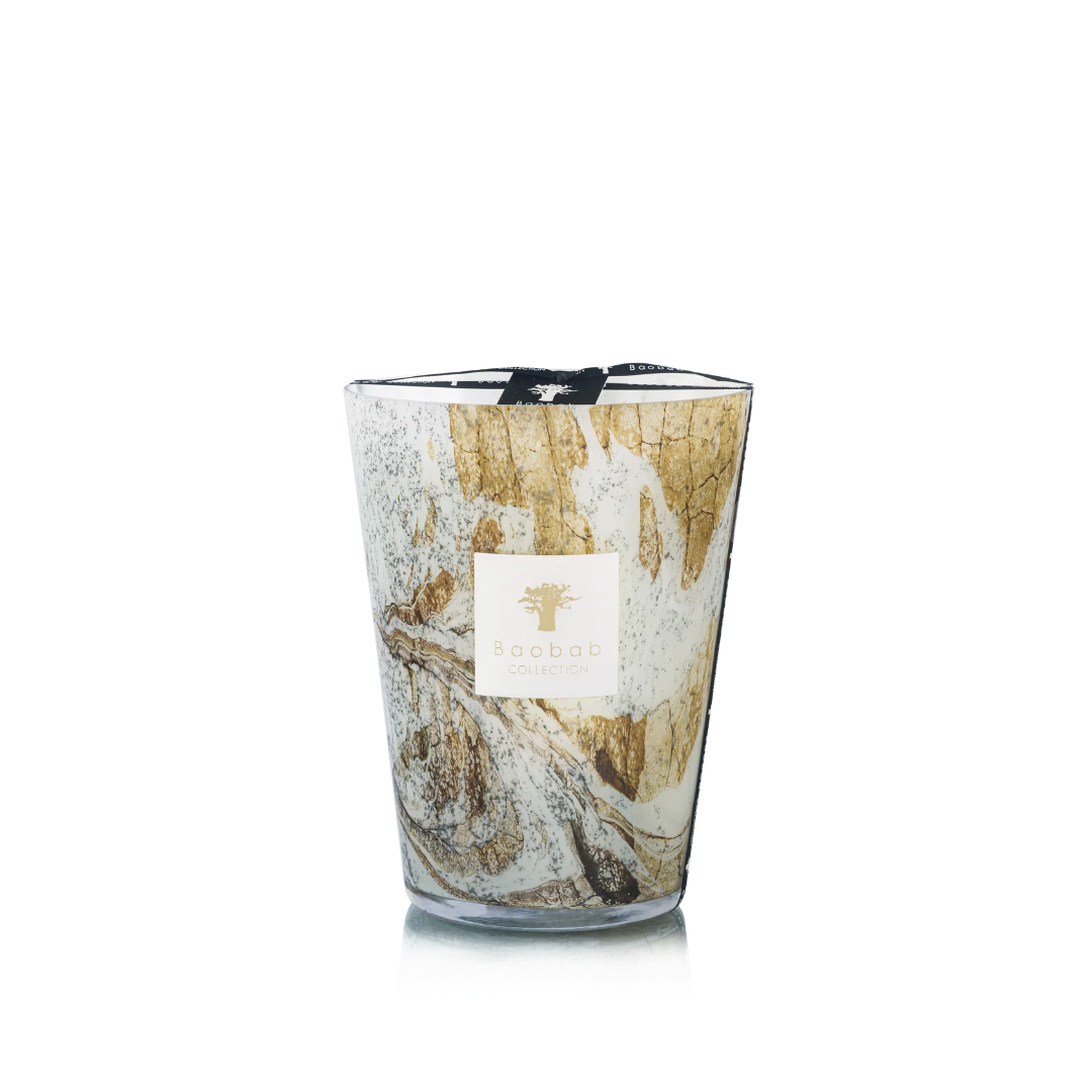 Candle in hand blown glass on a white background