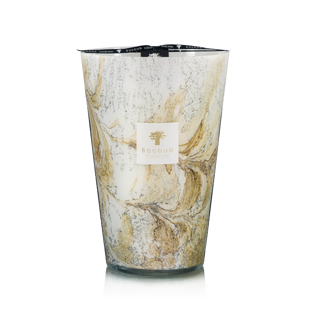 Hand blown glass candle with a visible brand label on a white background