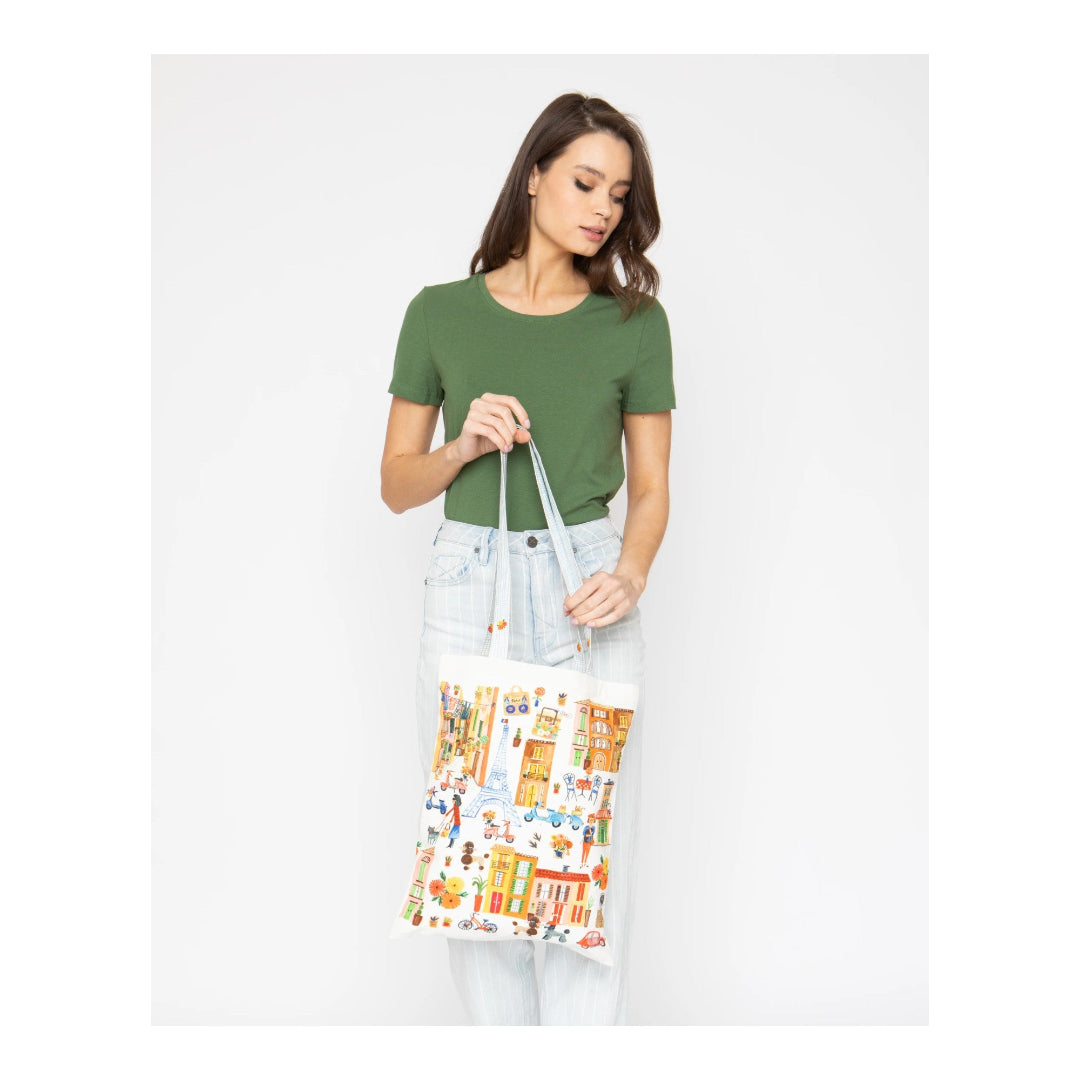 Woman holding a colorful tote bag with a white background
