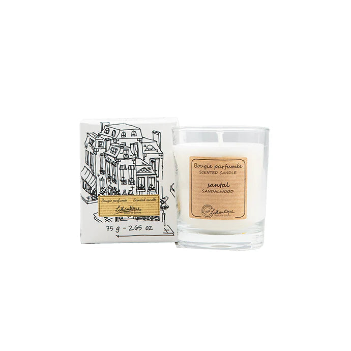 Candle with packaging featuring a building illustration on a white background