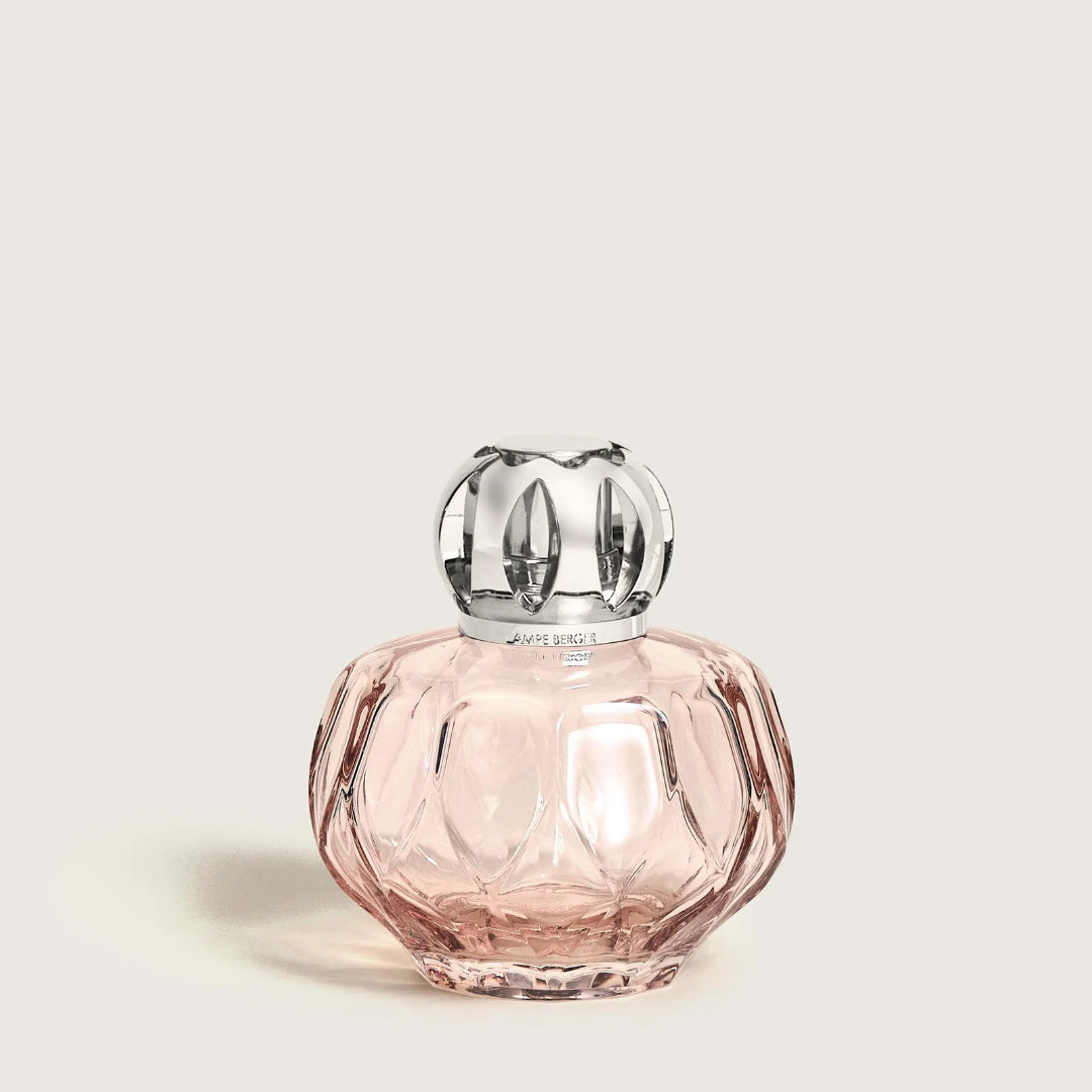 Pink lamp with silver cap on a light beige background