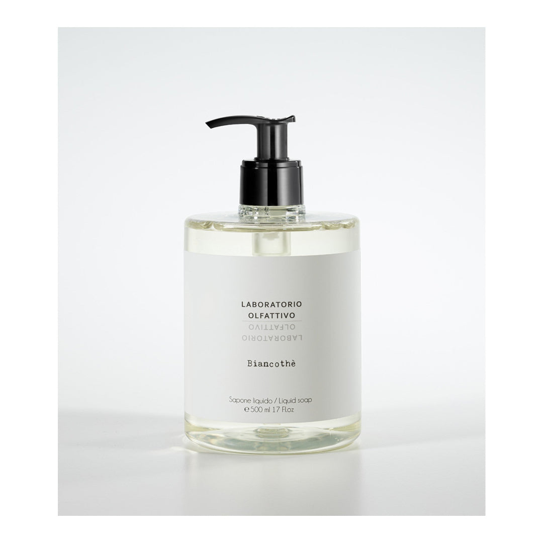 Clear liquid soap bottle with pump on a white background