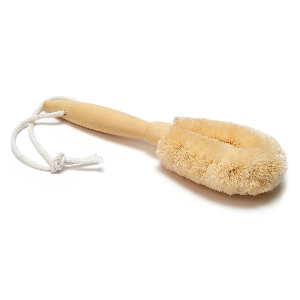 A beige colored sisal brush with a wooden handle, designed for dry brushing the body, with a loop for hanging.