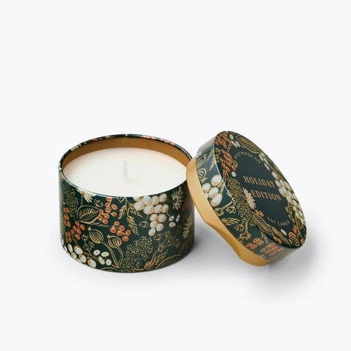 Decorative candle in a tin with floral design on a white background