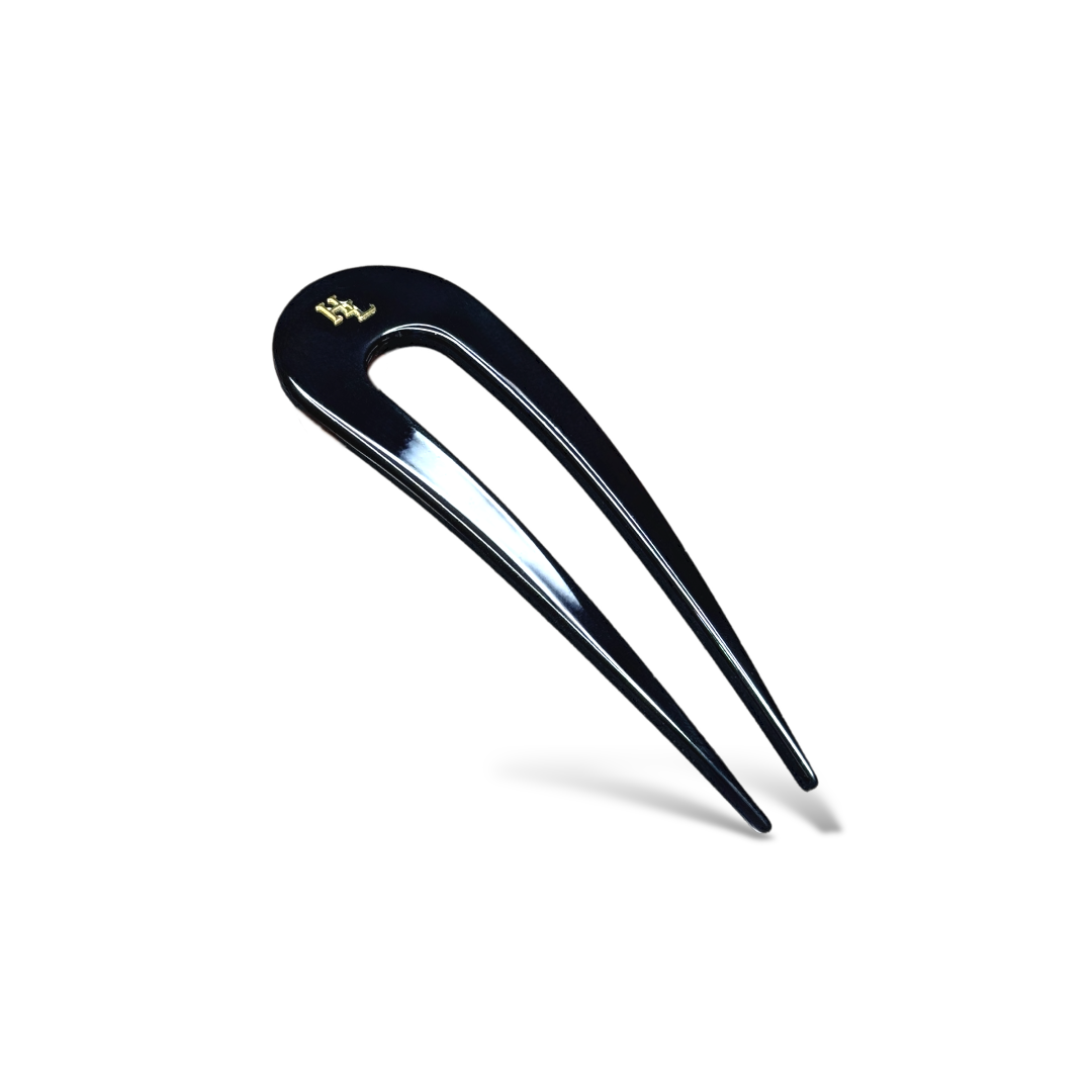 Black hairpin with gold logo on a white background