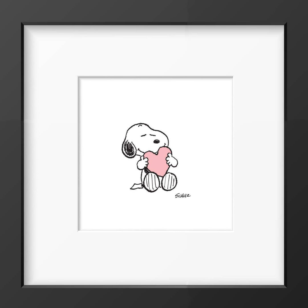 A framed print of Snoopy from Peanuts with a heart-shaped balloon, hand-made with a black frame and acrylic plexiglass glaze.