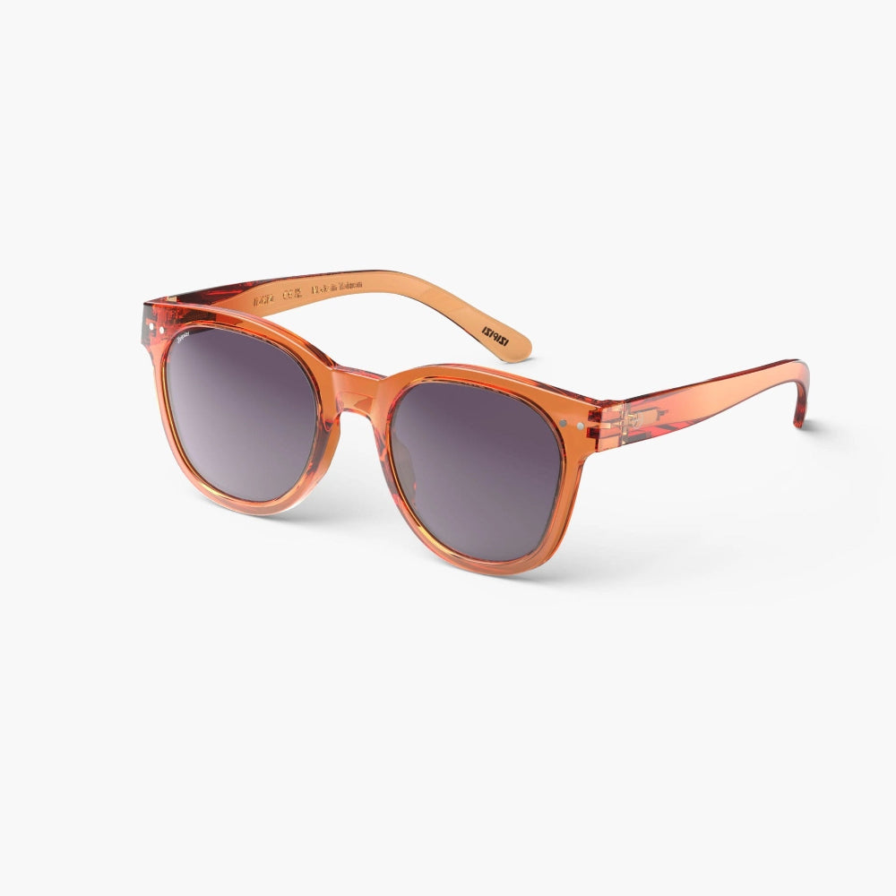 A pair of orange full-frame sunglasses with trapezoidal lenses, positioned against a white background.