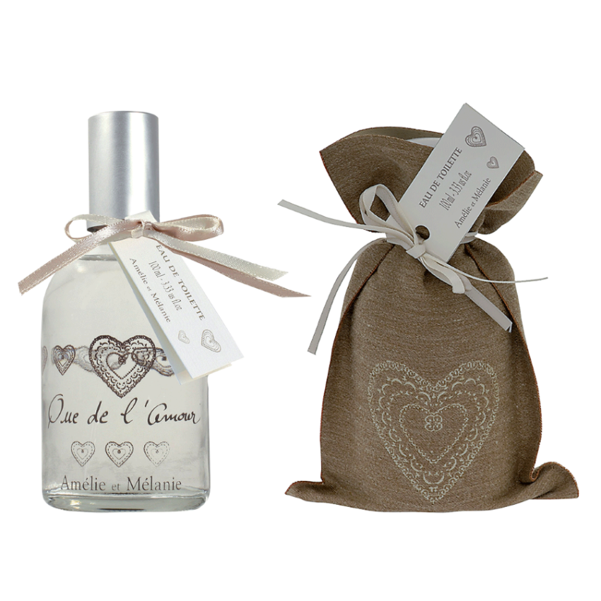Perfume bottle with decorative heart design and matching pouch on a white background