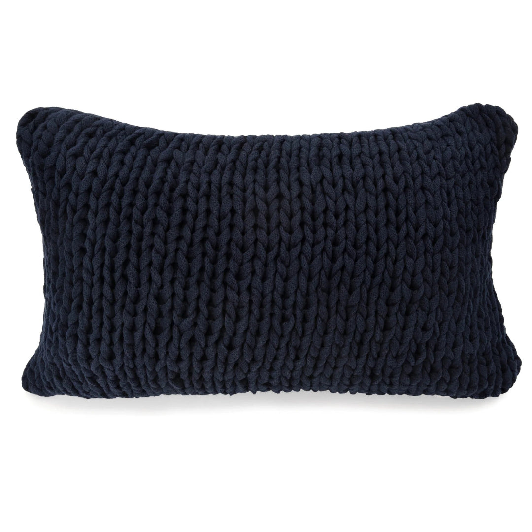 Two navy blue, hand-knit pillows of different sizes with a visible texture.