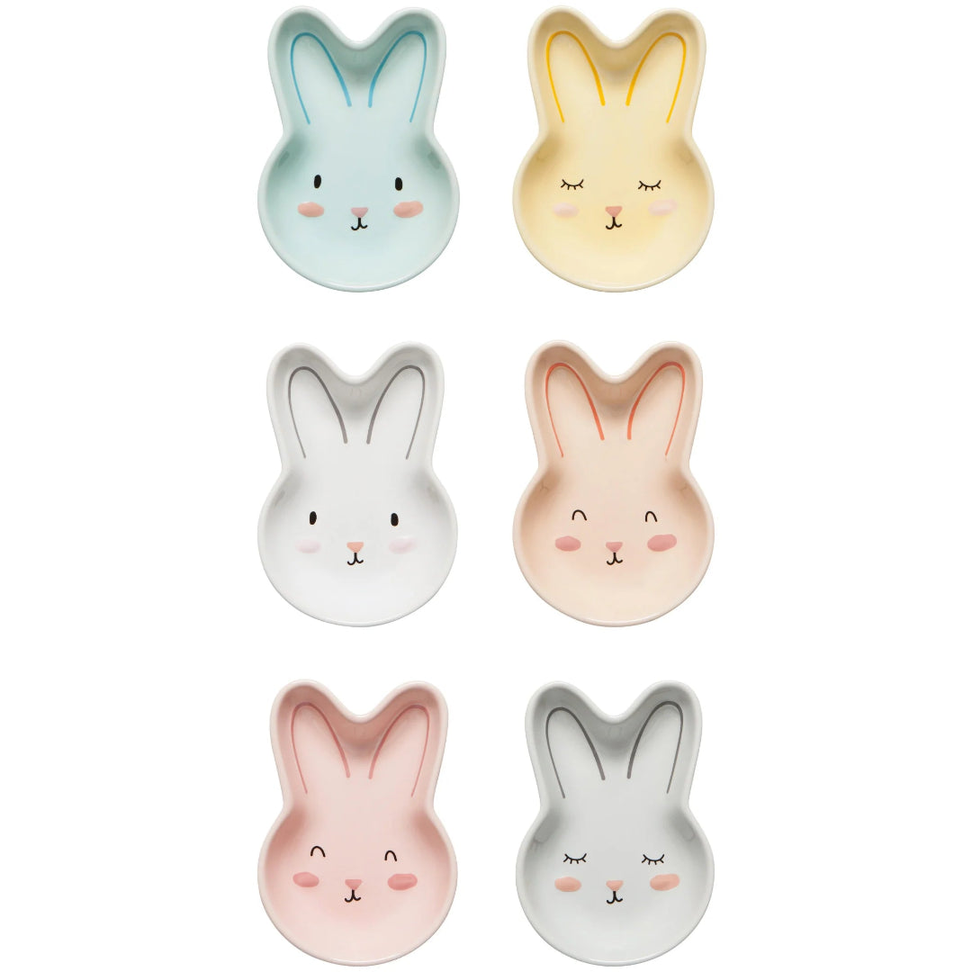 Set of six bunny-shaped ceramic plates in various colors on a white background