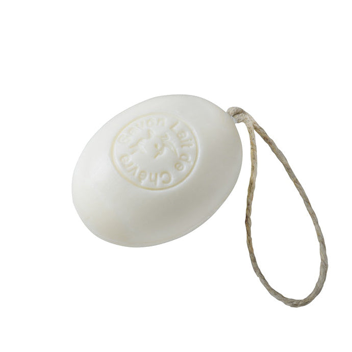 A white oval goat milk soap on a rope, with a rope attached to it.