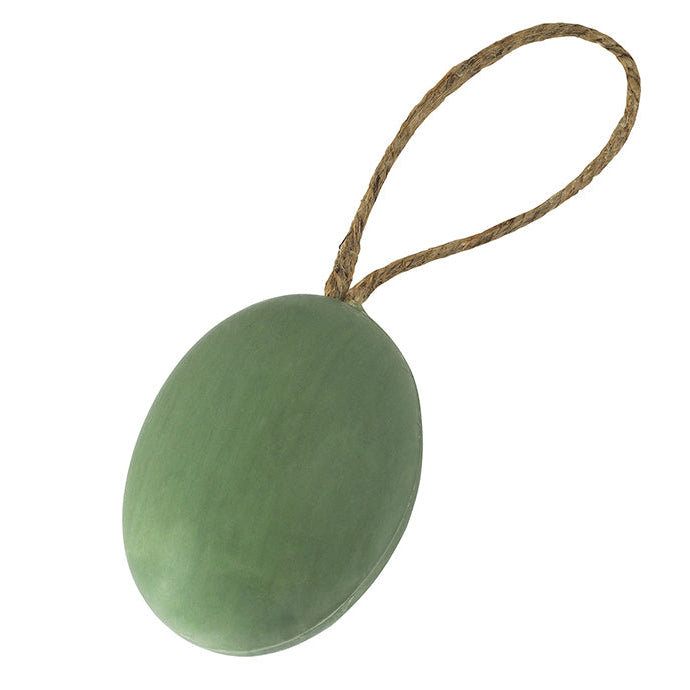 A bar of olive-scented soap attached to a rope, indicating it is artisanal soaps manufactured in Provence.