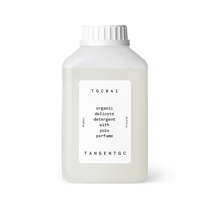A white bottle of Tangent GC Yuzu Delicate Detergent with a label that includes the brand name and the word 'yuzu'. The bottle is 500ml in size.
