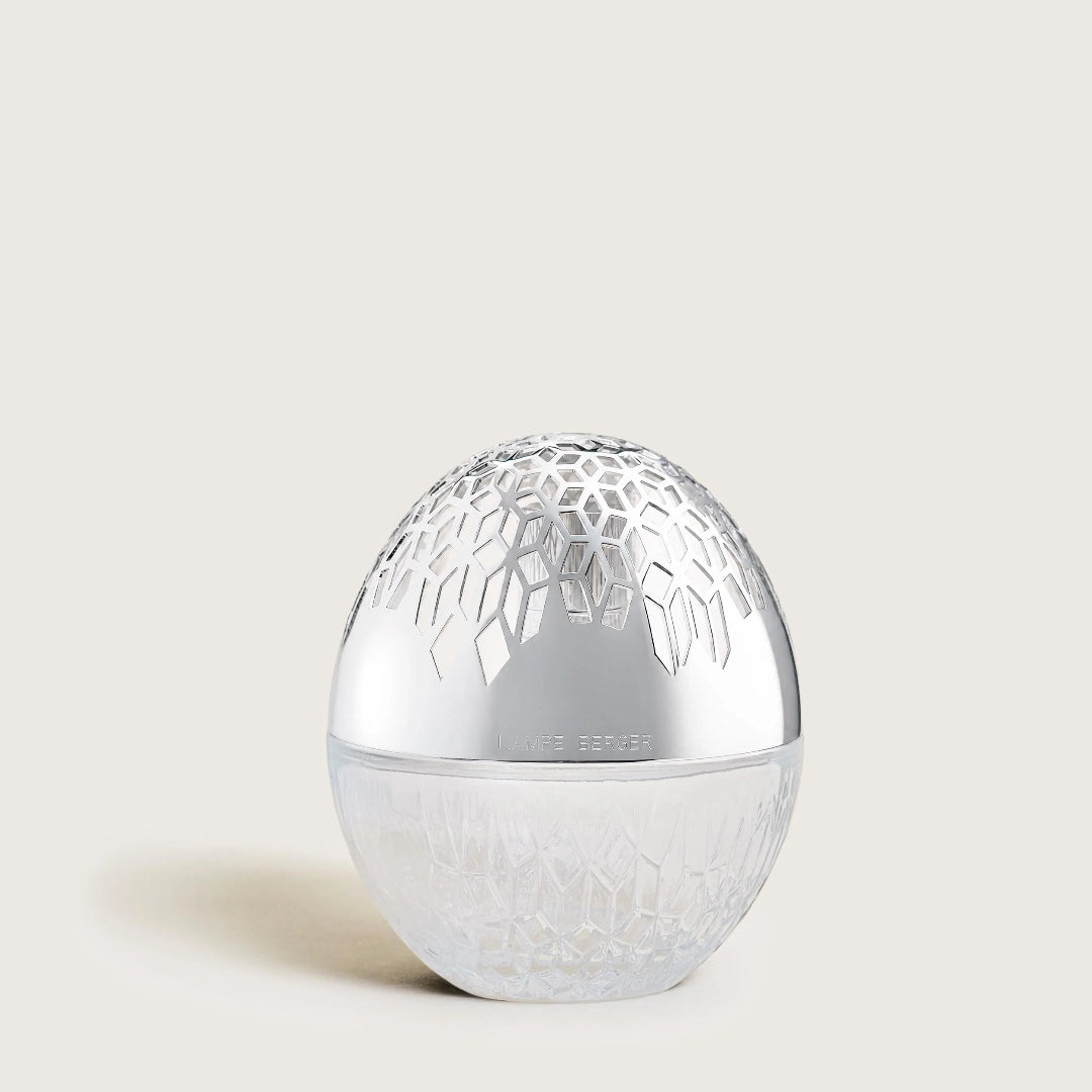 A silver egg-shaped Lamp with a textured pattern on the lid and a clear textured base