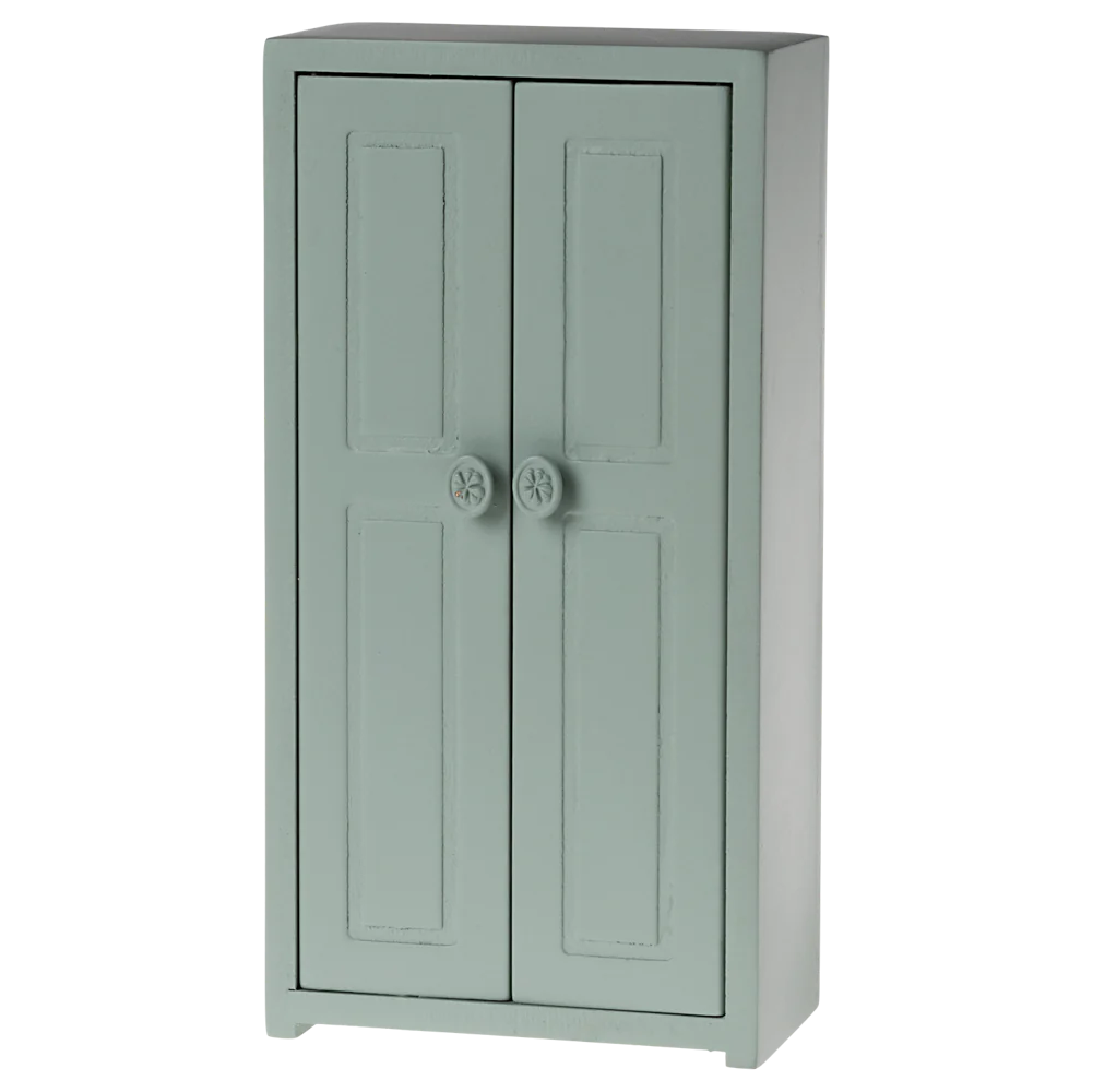 A small toy closet for mice with a soft blue color, featuring two doors and three golden hangers.