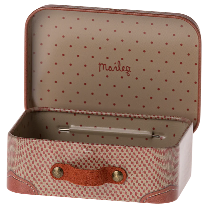 Small suitcase with polka dot interior and visible brand name on a white background