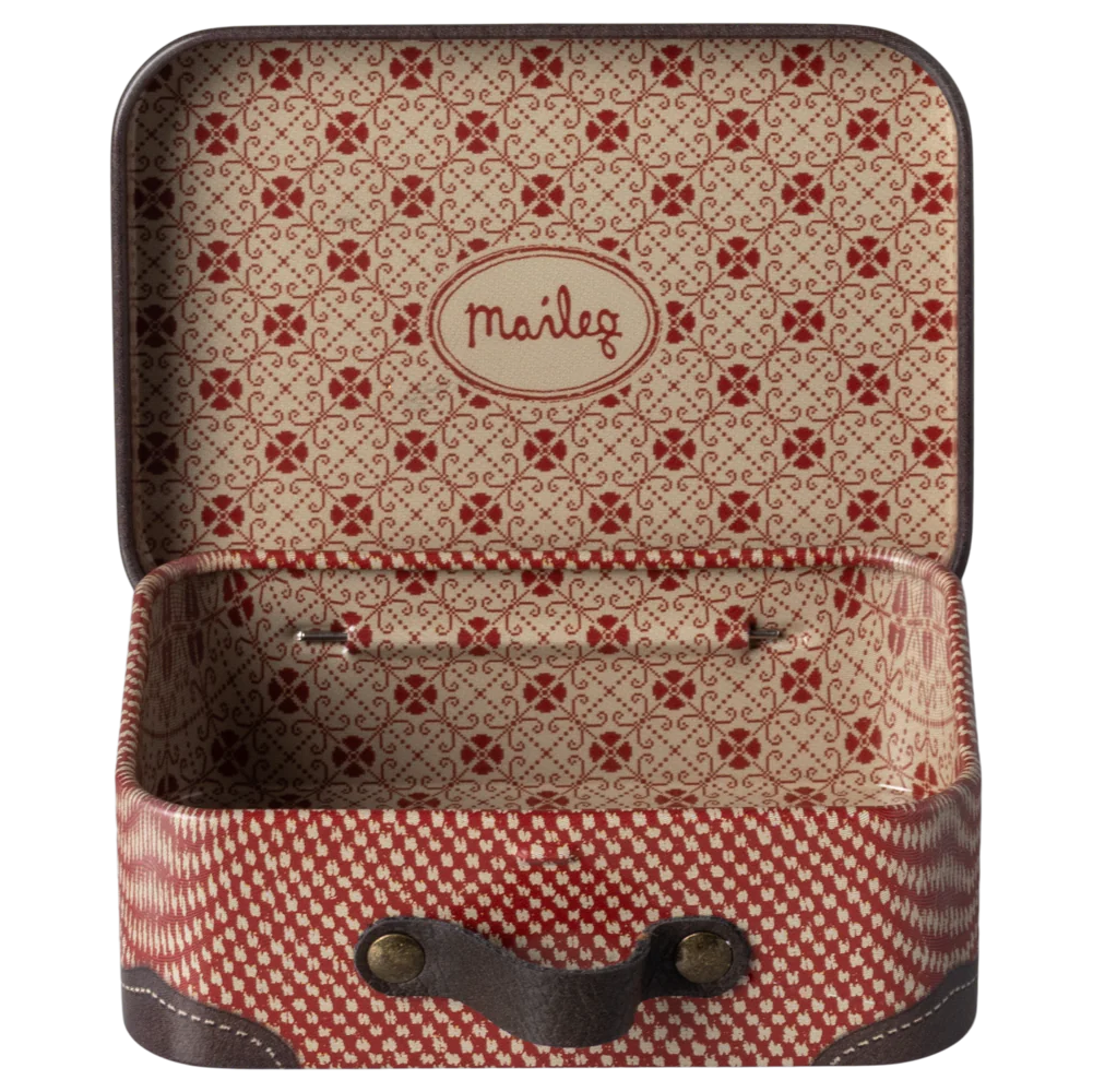 A small red and white metal suitcase with floral illustrations, open and empty, displaying the brand name 'Maileg' on the inside.