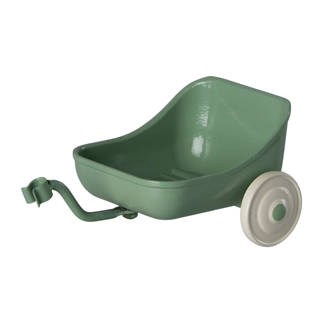 Green tricycle wagon with a white wheel on a white background